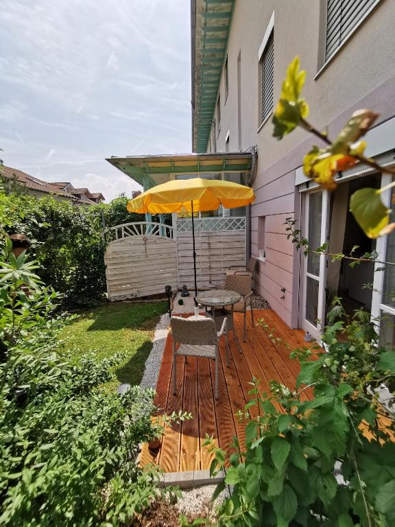 a patio with a table and an umbrella at Allgäu Apartment Kempten in Kempten