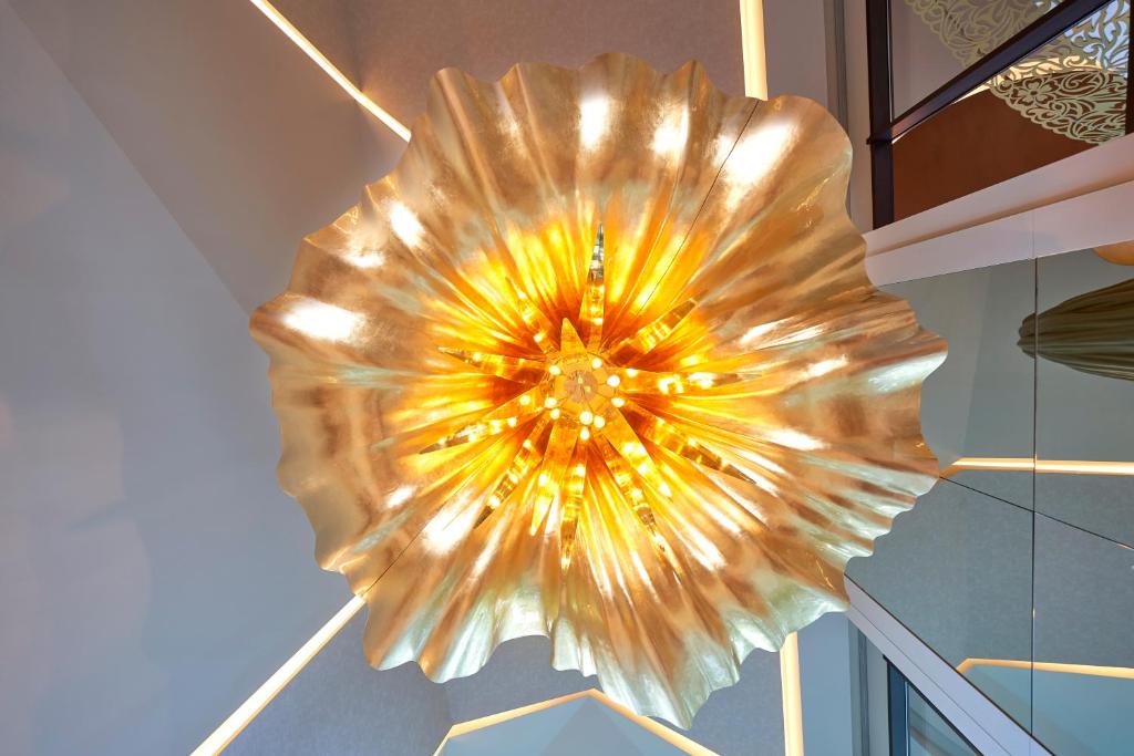 a circular light fixture hanging from a ceiling at Savoy Palace - The Leading Hotels of the World - Savoy Signature in Funchal