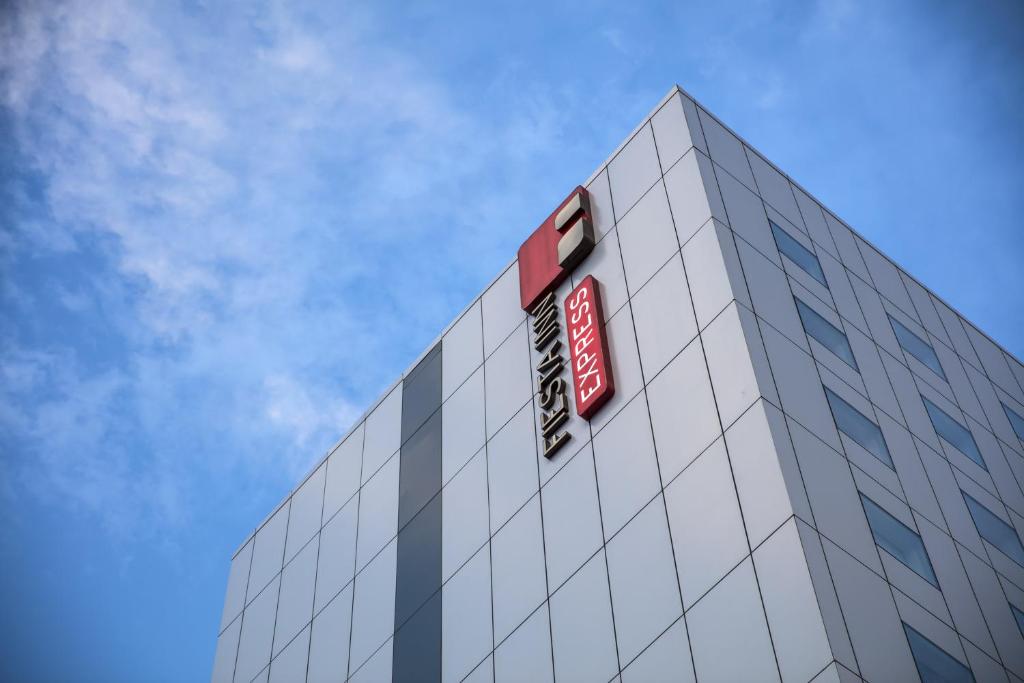 a building with a sign on the top of it at Fiesta Inn Express Monterrey Centro in Monterrey