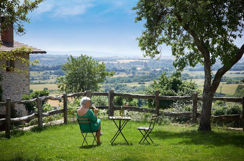 a woman sitting in a chair in the grass at HAIZATU in Manurga