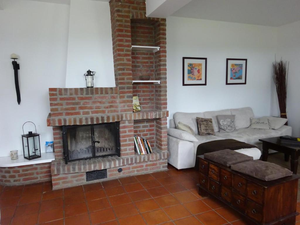 a living room with a brick fireplace and a couch at Ferienhaus mit Kamin in Xanten