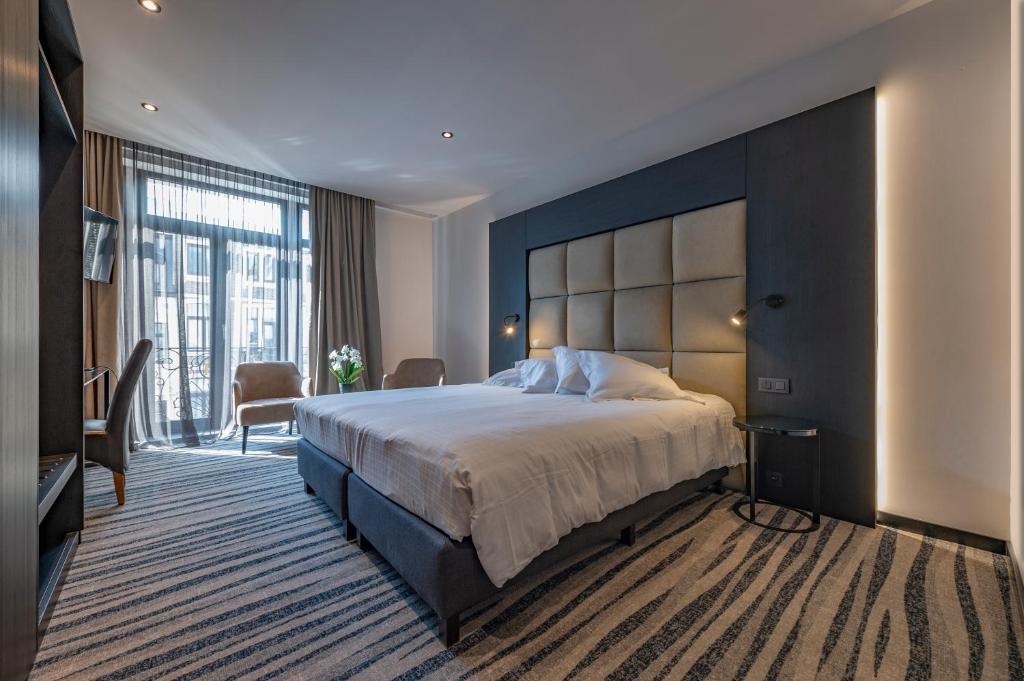 Postel nebo postele na pokoji v ubytování Hotel Monarc