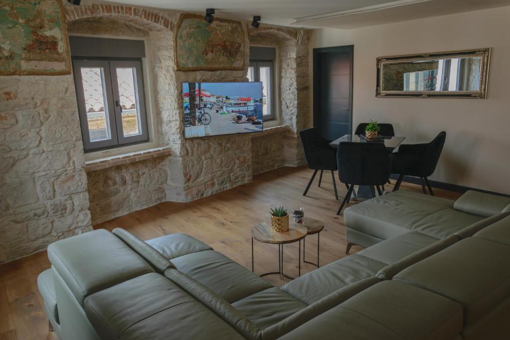 a living room with a couch and a table at Oli mare in Poreč