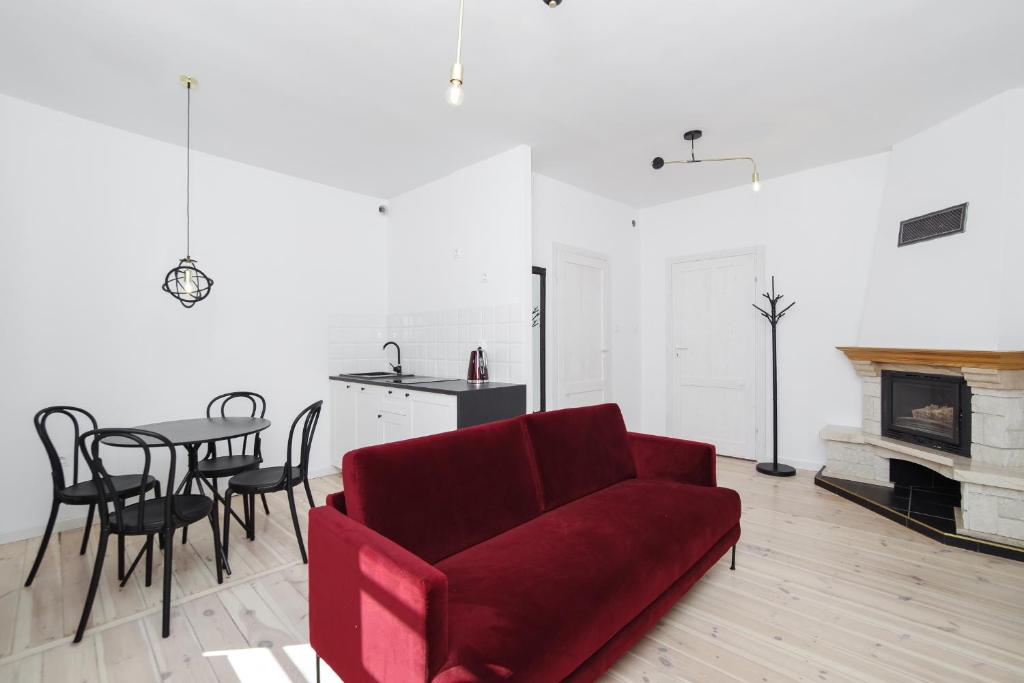 a living room with a red couch and a table at Sopotel in Sopot