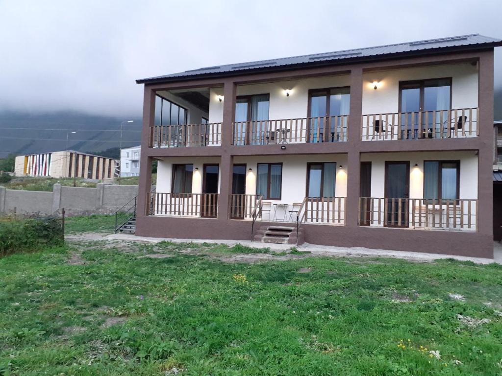 a building with balconies on the side of it at ELSADA in Stepantsminda