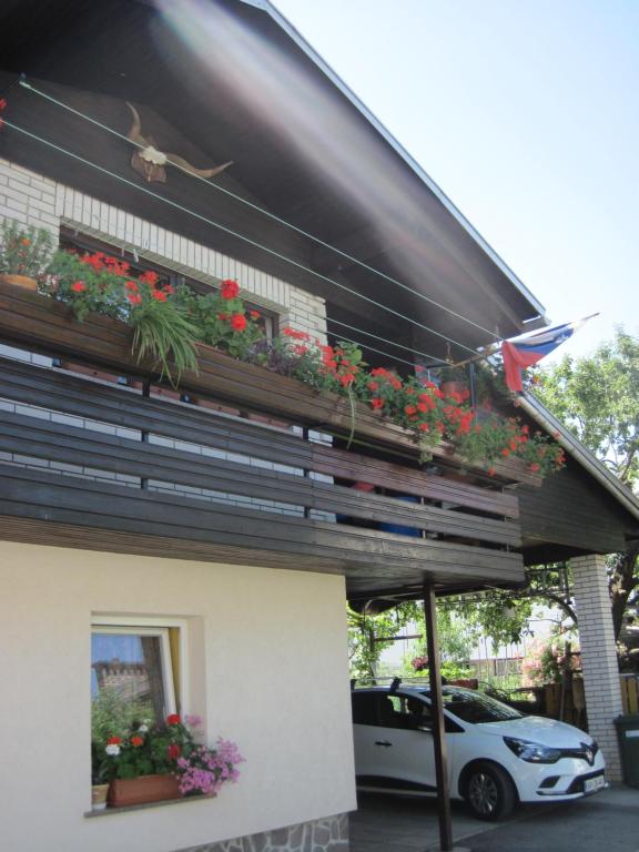 a building with a balcony with flowers on it at edelweiss in Radovljica