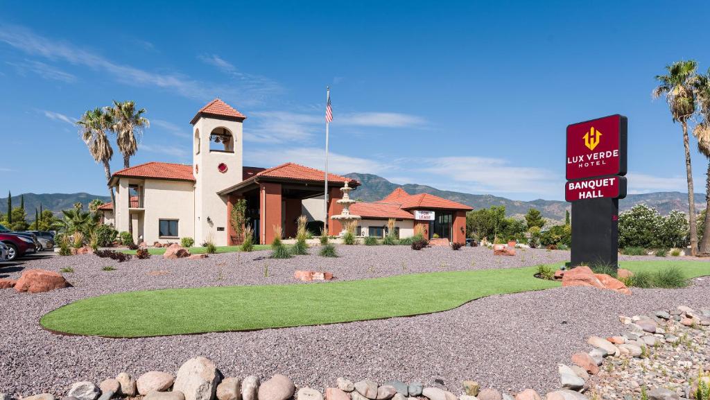 a sign in front of a building with a church at Lux Verde Hotel in Cottonwood
