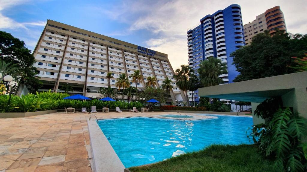 a hotel with a swimming pool in front of a building at Blue Tree Towers Rio Poty in Teresina