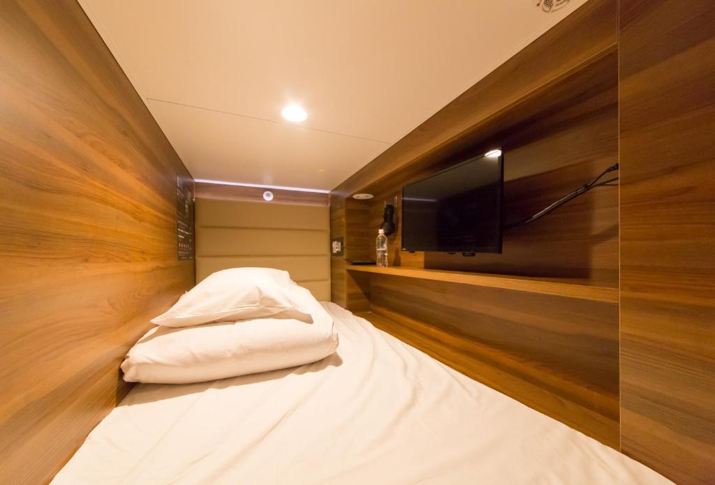 Postel nebo postele na pokoji v ubytování Sauna & Capsule AMZA (mens only)
