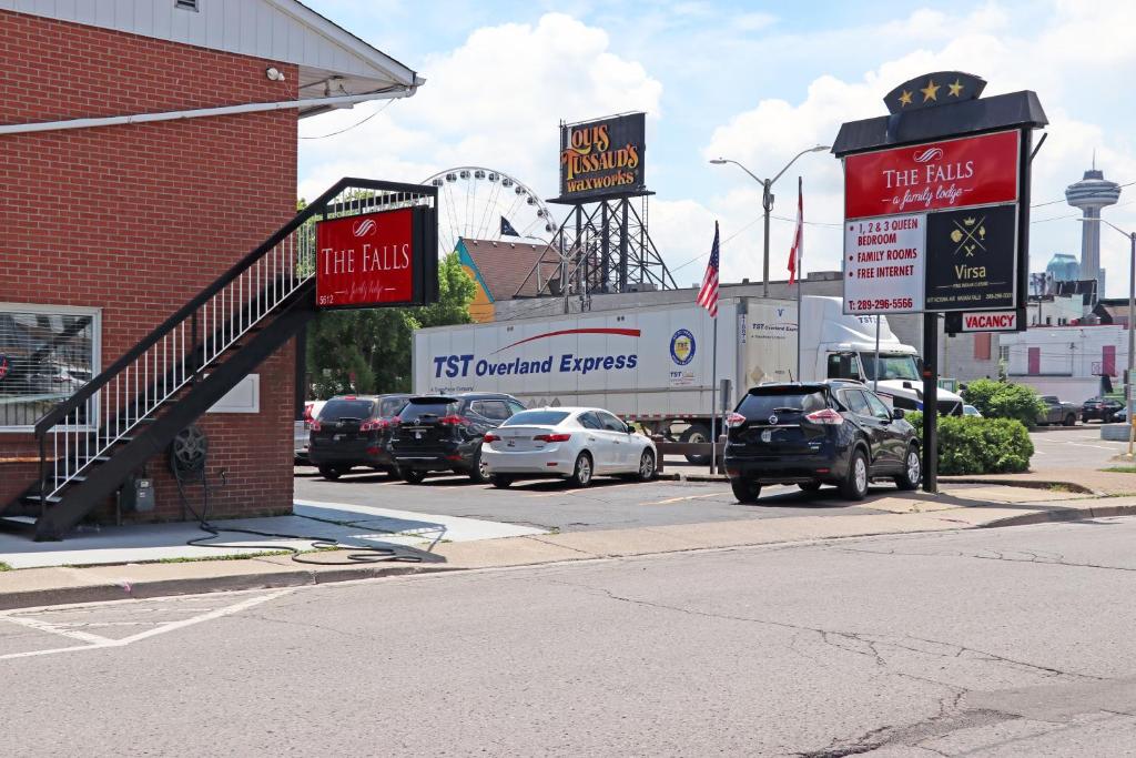 a street with cars parked in front of a fast food restaurant at The Falls Family Lodge in Niagara Falls