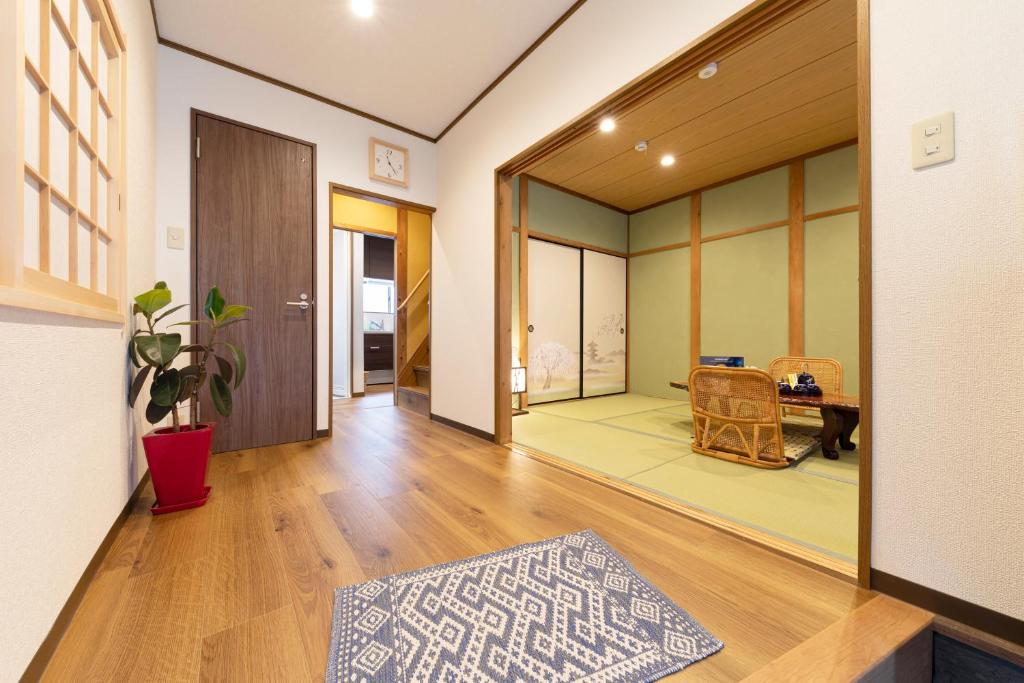 a living room with a hallway with a table at Shirakabanoyado - Uehonmachi in Osaka