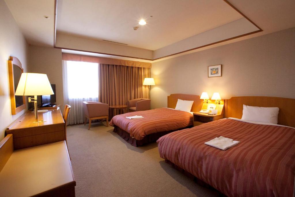 Postel nebo postele na pokoji v ubytování Hotel Mielparque Nagoya