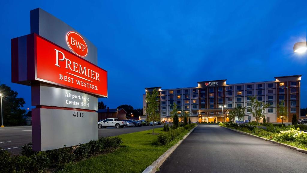 a sign for a perrier hotel in a parking lot at Best Western Premier Airport/Expo Center Hotel in Louisville