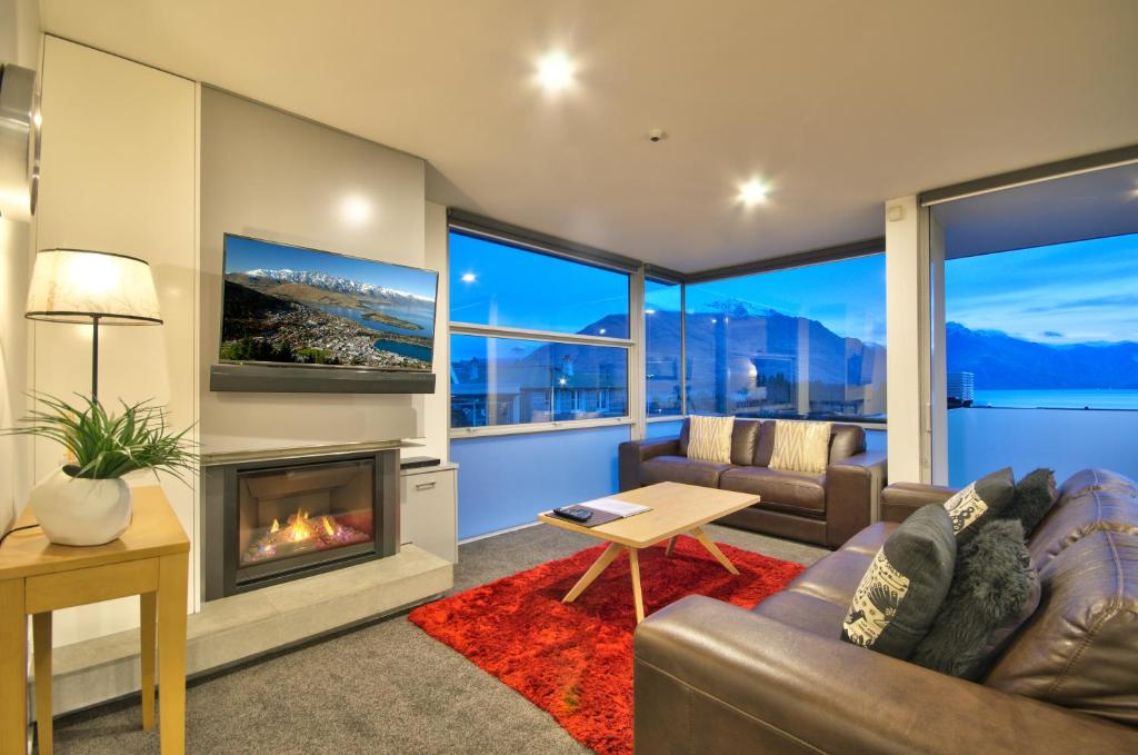 a living room with a couch and a fireplace at Highview Central in Queenstown