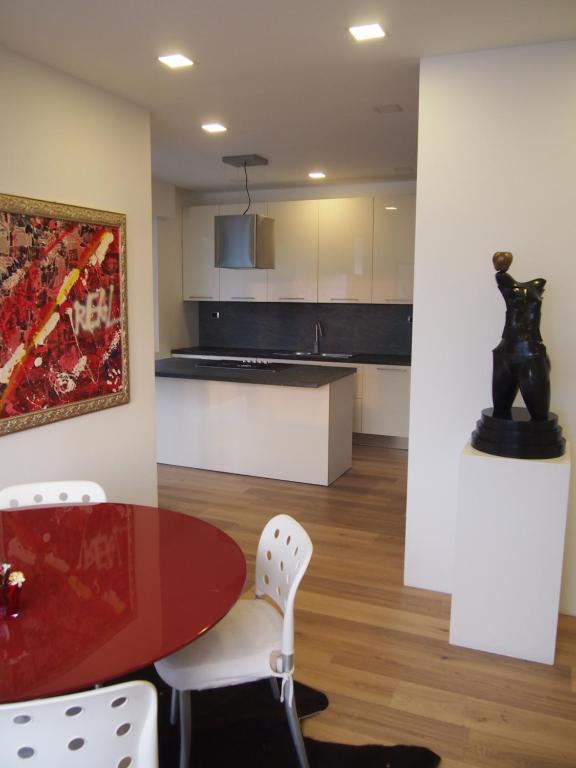 a kitchen and dining room with a table and chairs at CasaPi' in Torri del Benaco