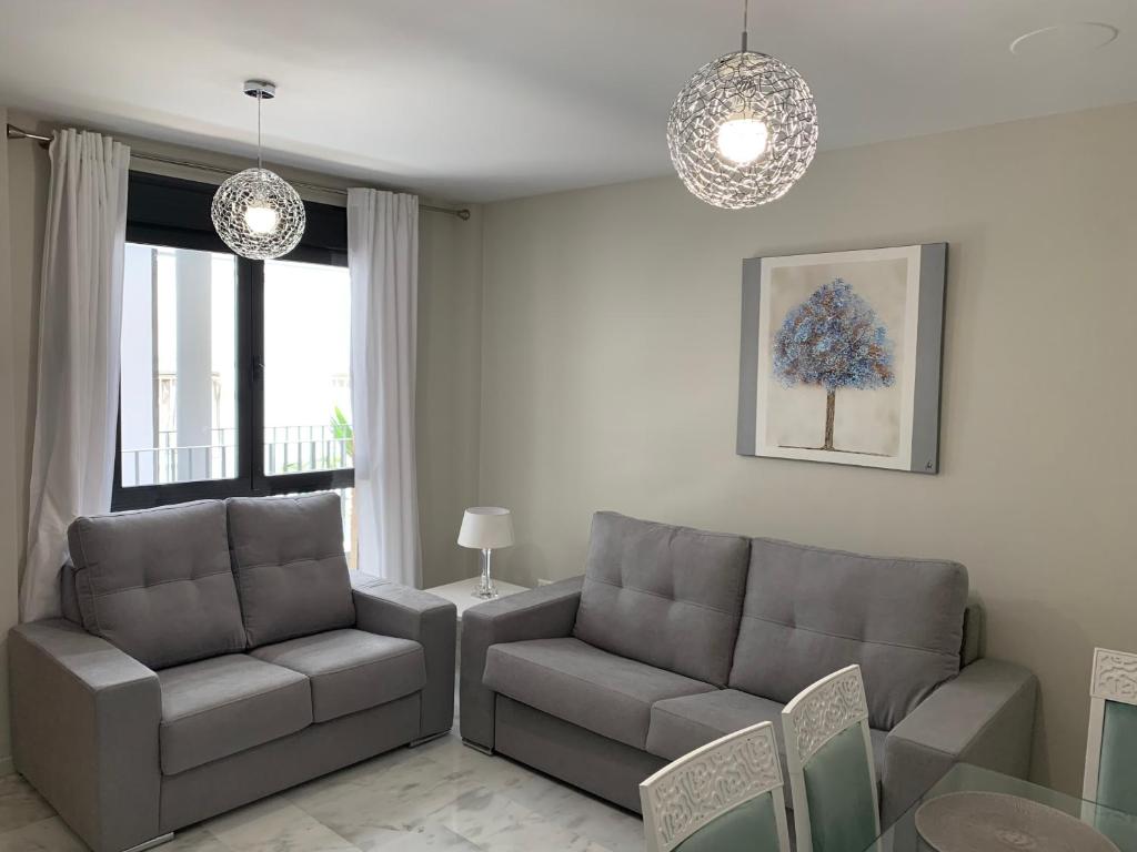 a living room with two chairs and a couch and a table at Apartment Lucena Center Bajo in Lucena