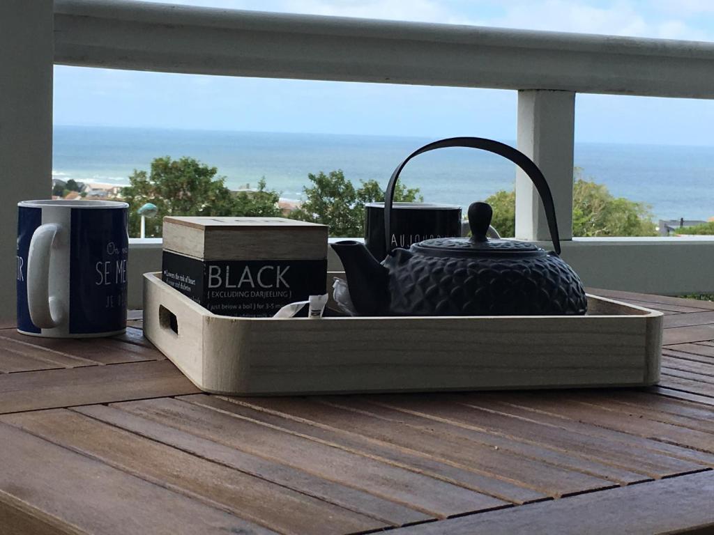 a tray with a black tea pot on a table at Cap Bleu in Blonville-sur-Mer