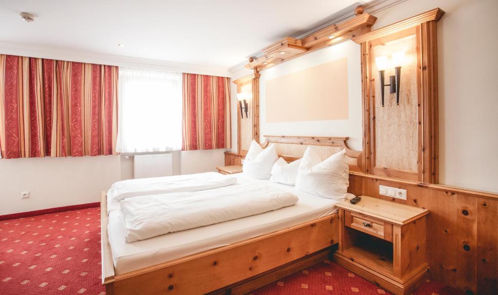 a bedroom with a large bed in a room at Gasthof Schmalzerhof in Weer