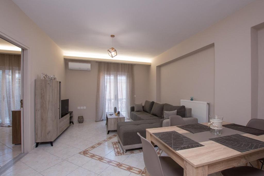 a living room with a table and a couch at Nobbi Apartment in Zakynthos Town