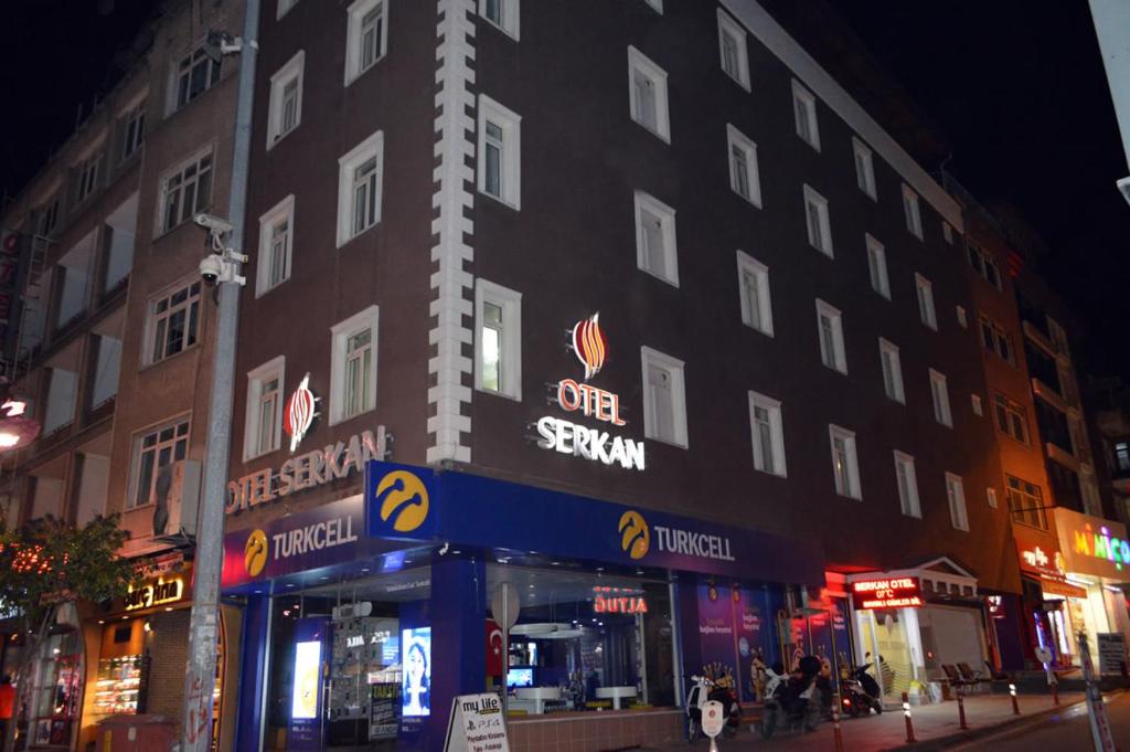 a building on a city street at night at OTEL SERKAN in Isparta