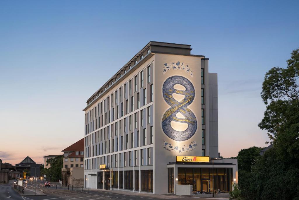 a building with a sign on the side of it at Super 8 by Wyndham Dresden in Dresden