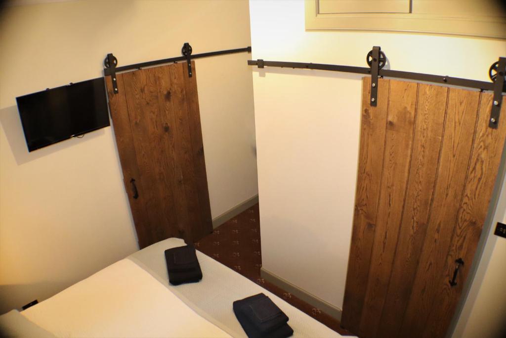 a room with two wooden doors in a room at The Victoria Inn Blythswood Snug in Falkirk