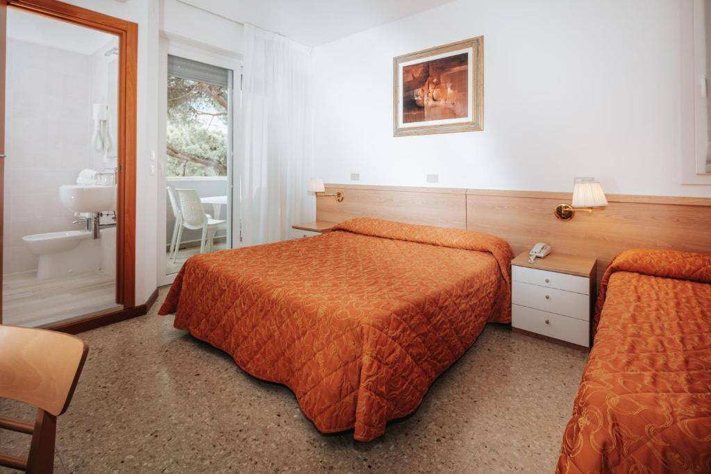 A bed or beds in a room at Hotel Meublè Zenith