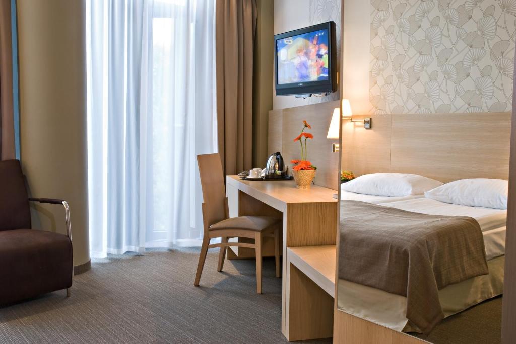Postel nebo postele na pokoji v ubytování Rixwell Elefant Hotel