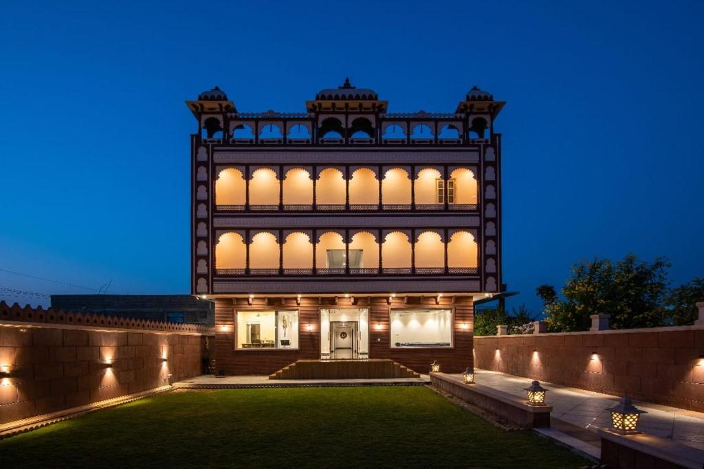 a house with a lit up facade at night at Hotel The Balam in Jodhpur