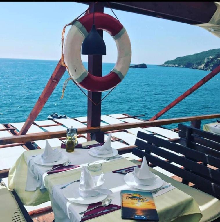 a table on a boat in the ocean with a lifesaver at Guesthouse DONA in Ulcinj
