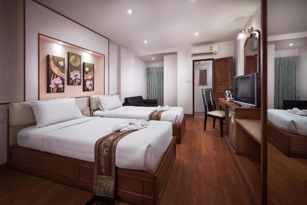 Postel nebo postele na pokoji v ubytování KC Place Hotel Pratunam
