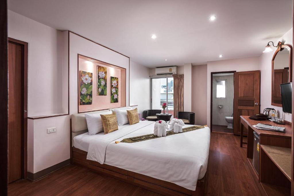 Postel nebo postele na pokoji v ubytování KC Place Hotel Pratunam