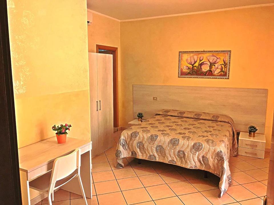 a bedroom with a bed and a table and a desk at B&B Da Felice in Serino