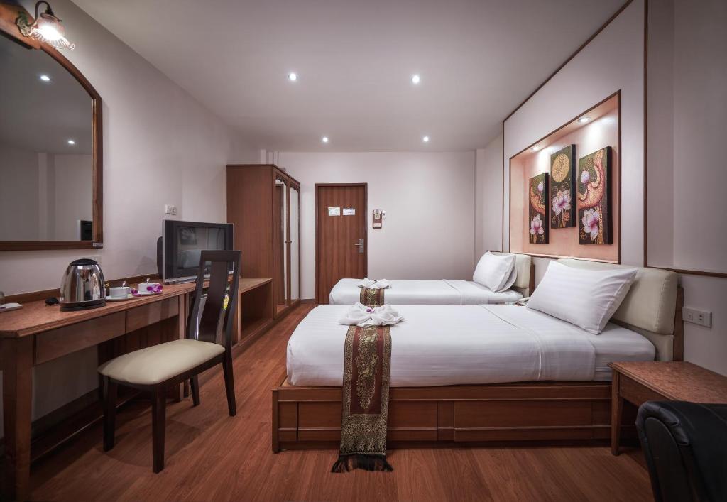 Postel nebo postele na pokoji v ubytování KC Place Hotel Pratunam