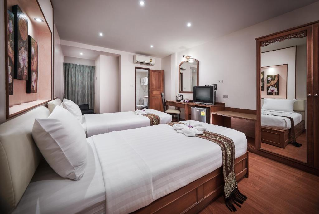 Postel nebo postele na pokoji v ubytování KC Place Hotel Pratunam
