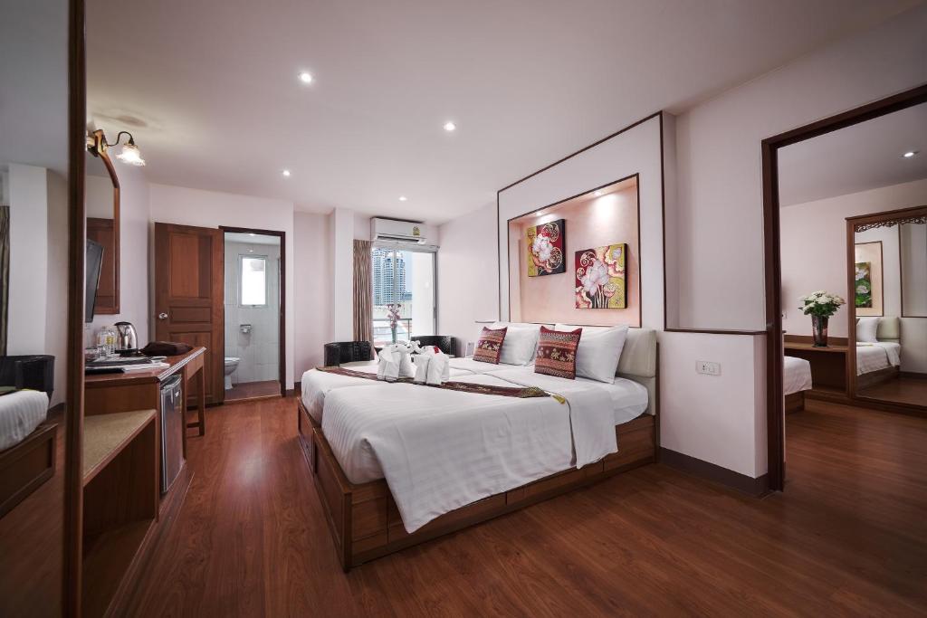 Postel nebo postele na pokoji v ubytování KC Place Hotel Pratunam