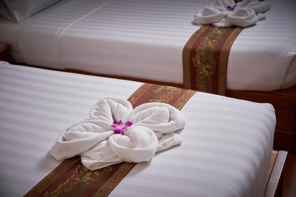 Postel nebo postele na pokoji v ubytování KC Place Hotel Pratunam