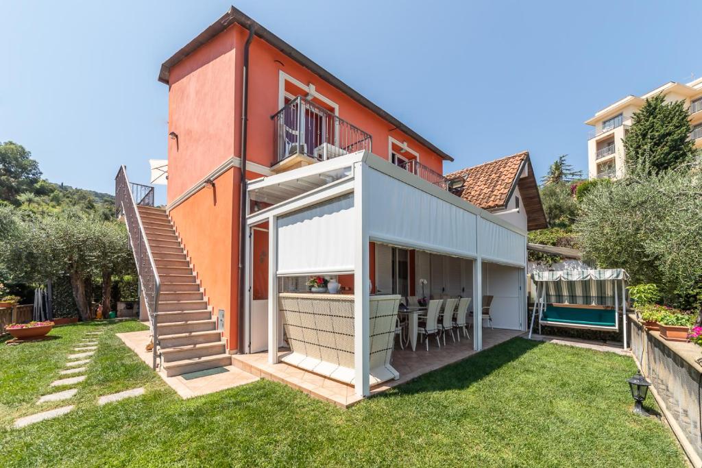 a house with a large backyard with grass at Il Viaggio in Diano Marina