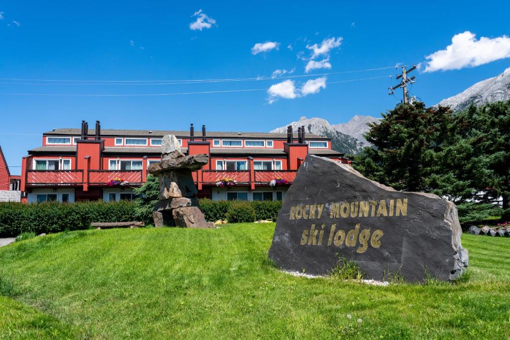 a large rock in front of a building at Rocky Mountain Ski Lodge in Canmore