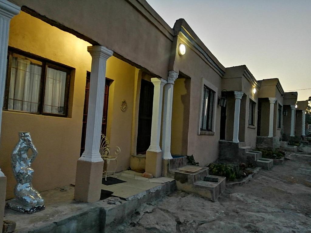 an old house with columns at Rocks And Aloes Guest Lodge in KwaGamalakhe