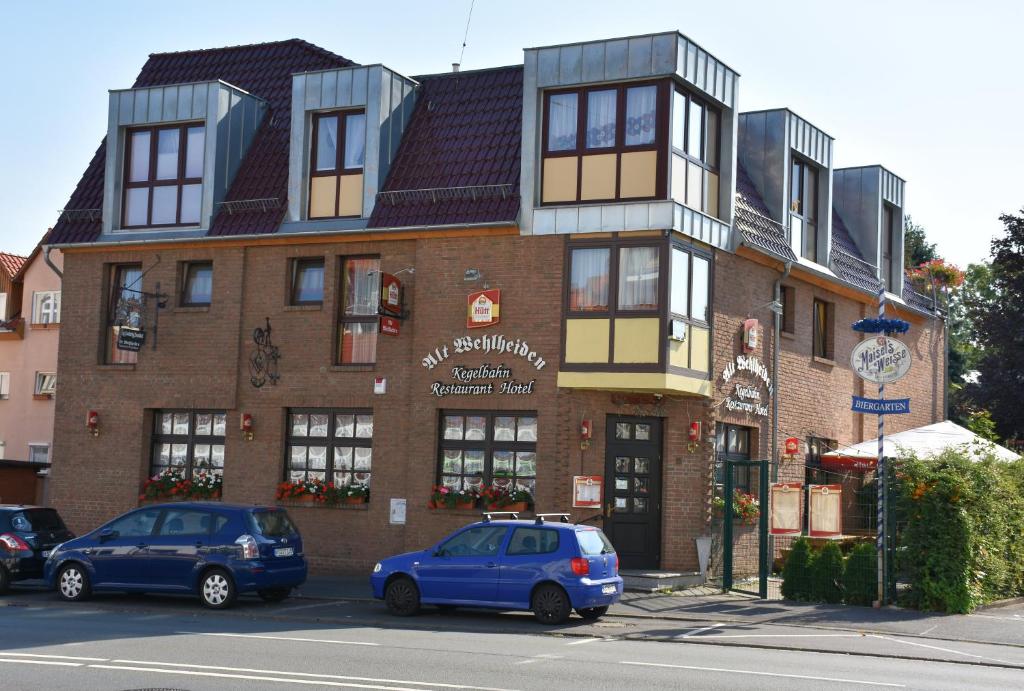 a building with two cars parked in front of it at Alt Wehlheiden in Kassel