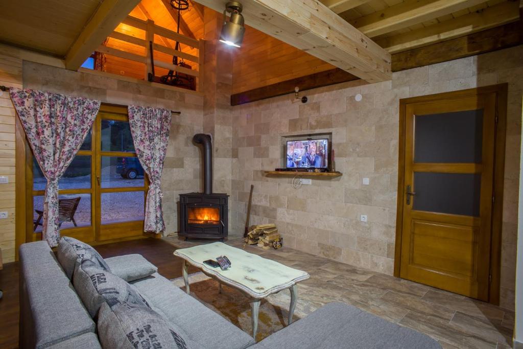 a living room with a couch and a wood stove at Chalet F&V Radosavović in Žabljak
