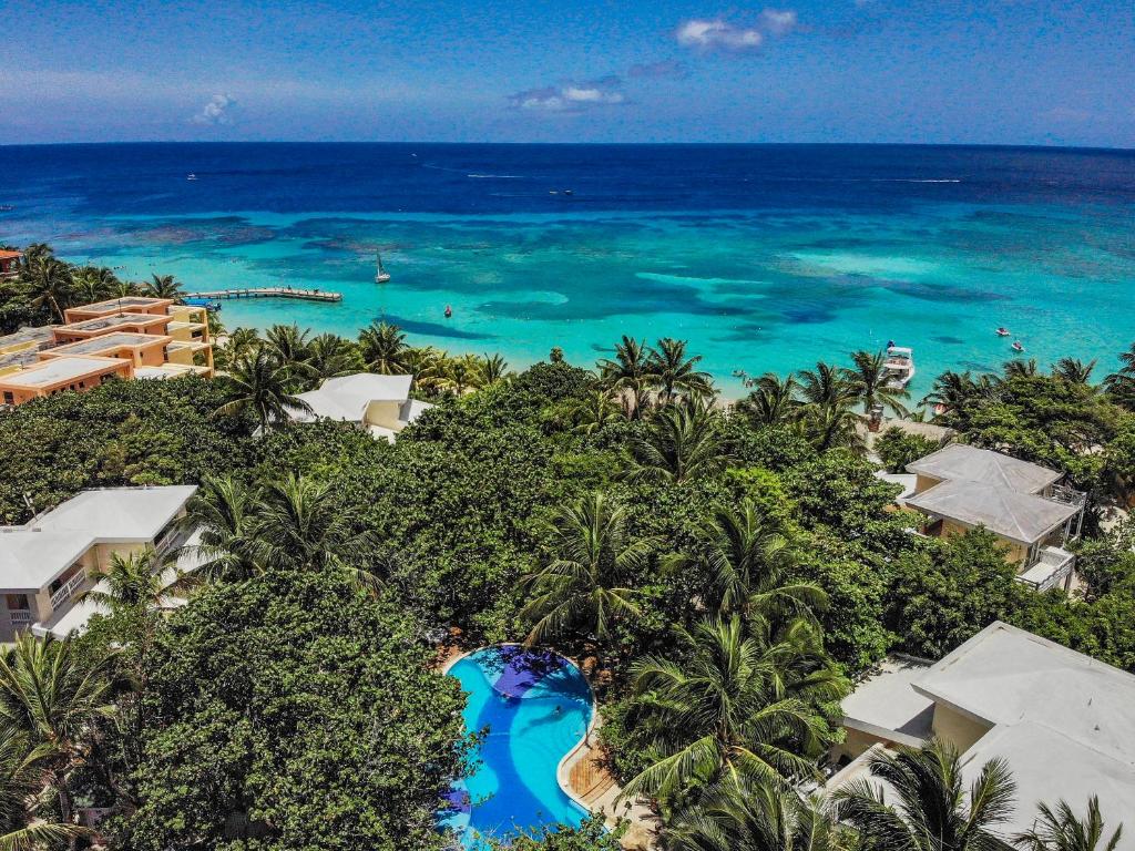 an aerial view of a resort and the ocean at Paradise Beach Hotel in West Bay