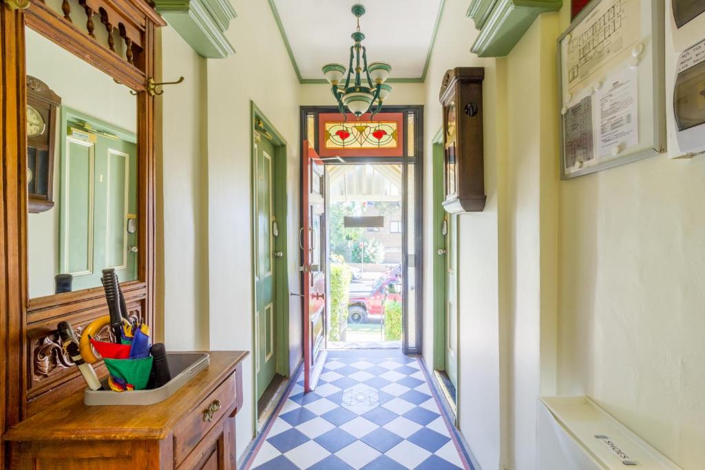 a hallway with a tile floor and a hallway with a mirror at Randwick City Lodge 2 in Sydney
