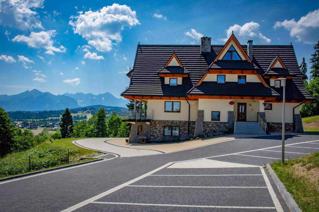 a house on the side of a road at Willa Góralskie Klimaty in Bukowina Tatrzańska