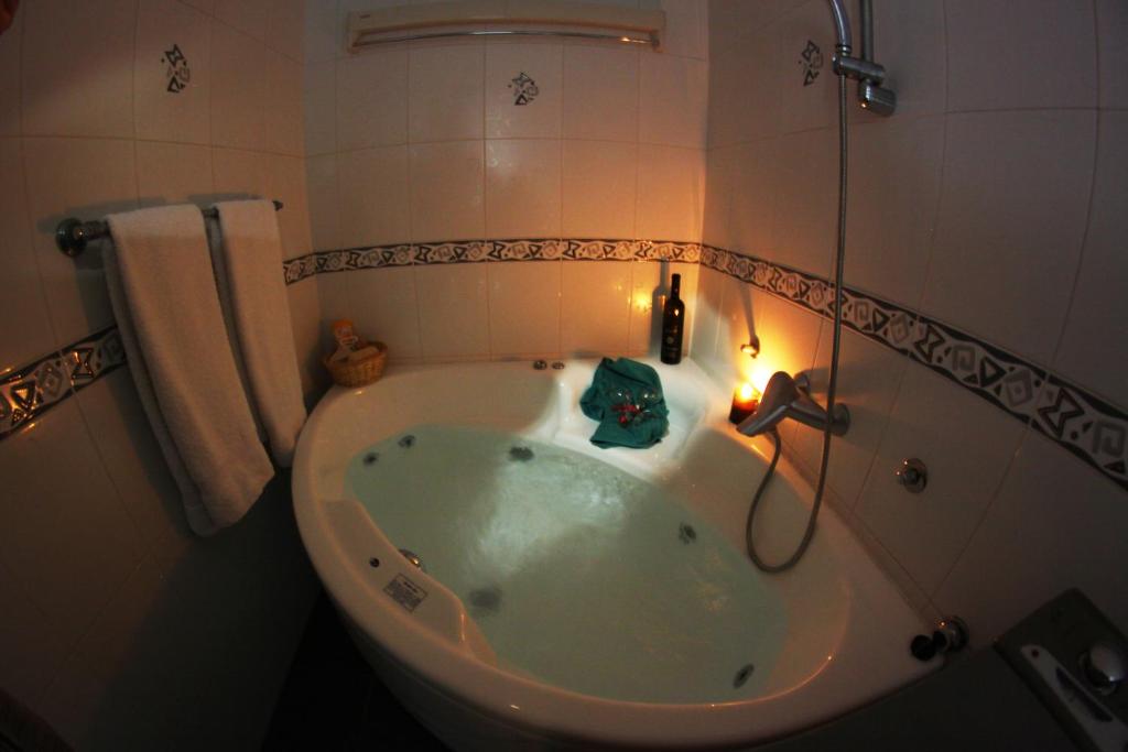 a bath tub with a candle in a bathroom at St. Marko Church App in Belgrade