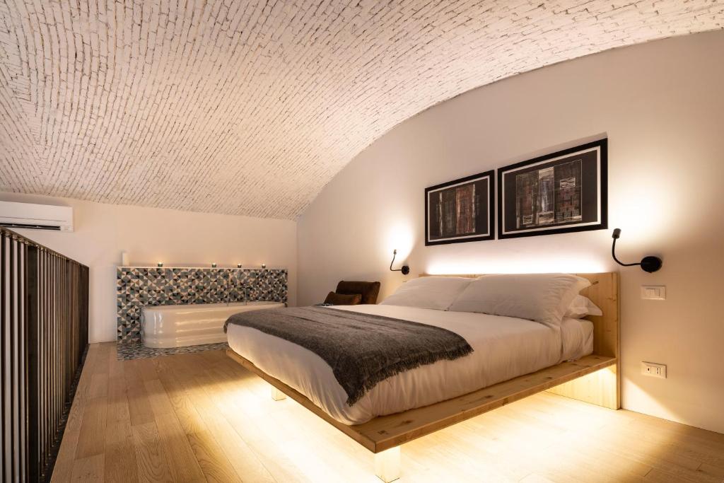 a bedroom with a bed and a white ceiling at Design Loft Corte Kalister in Trieste