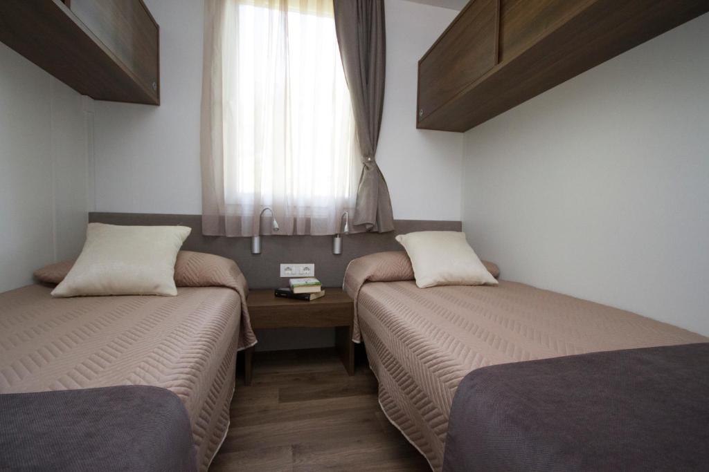 Postel nebo postele na pokoji v ubytování Camping Santin