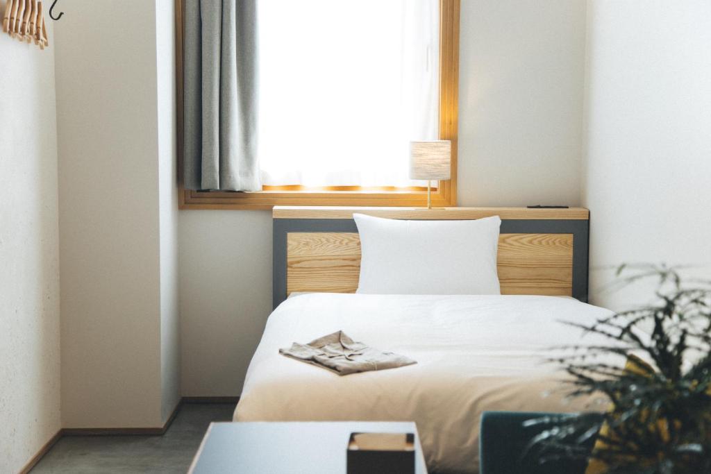 Postel nebo postele na pokoji v ubytování Hotel Noum OSAKA