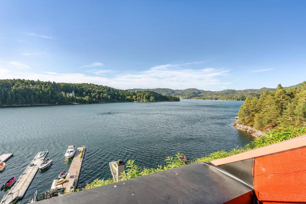 a view of a river with boats on a dock at Villa Oleanna in Lysekloster